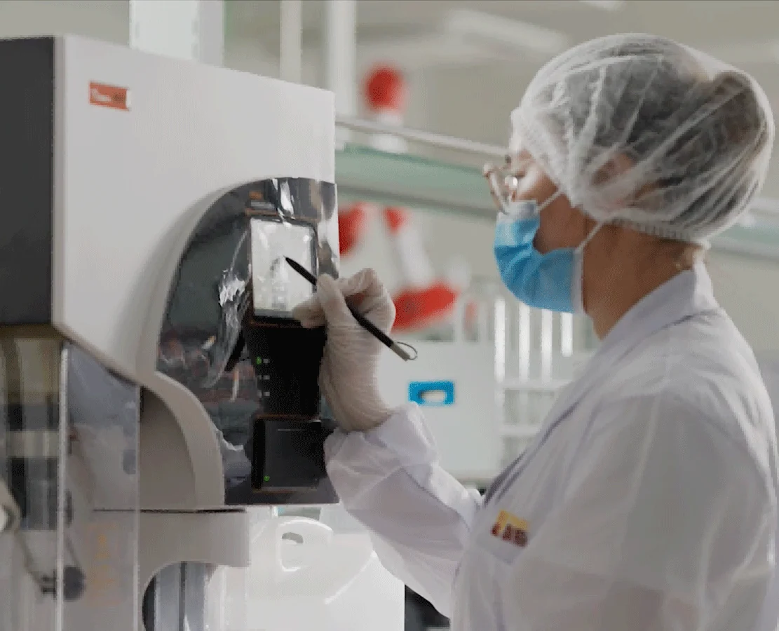 Yihai laboratory specialist checking an analytical instrument